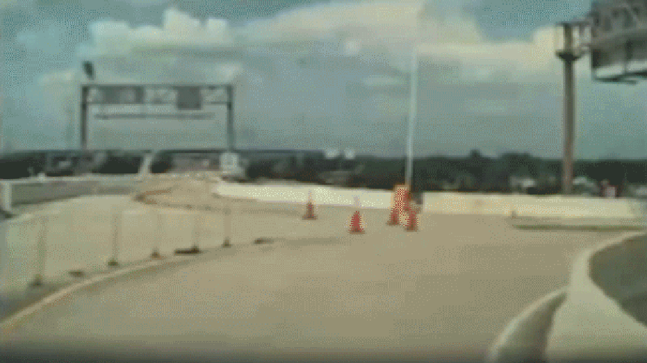 gif of dashcam video showing car crashing into overpass barrier